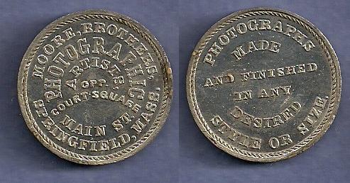 JAB-21 MOORE BROTHERS PHOTOGRAPHY Tin
28mm -  400 struck

Dies were cut in 1865 and presumably given to the Moore Brothers.  They are currently unaccounted for.

The Moore Brothers were jointly in Business at 441 Main Street in Springfield, Mass. from 1859 through 1877.  During the Civil War, they photographed every new recruit from Springfield and provided copies at no charge.  

Although it is accepted that there were 400 pieces struck in Tin, the piece is much rarely than the mintage would indicate.  A silvered edge lettered example sold for $550 in a Hayden 8/2015 Sale.  A NGC-63 example sold for $264 in the 9/2021 Stacks sale, lot 70119
Keywords: bolen moore photography